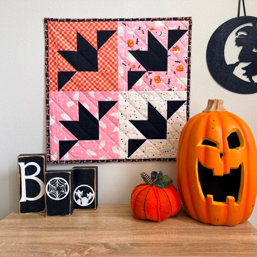 Halloween Bat mini quilt on the wall above a table